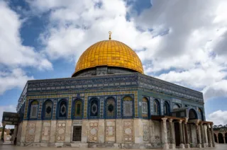 The golden Dome of the Rock on the Temple Mount beneath a dramatic cloudy sky